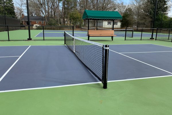 Outdoor permanent striped green and blue pickleball courts